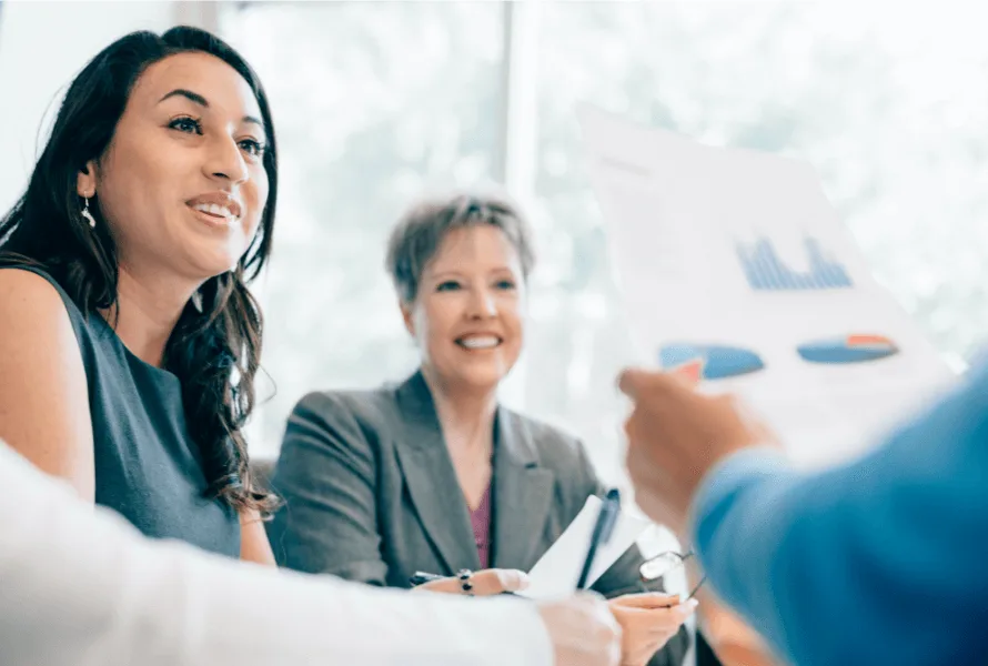 Account management meeting with two woman looking at data