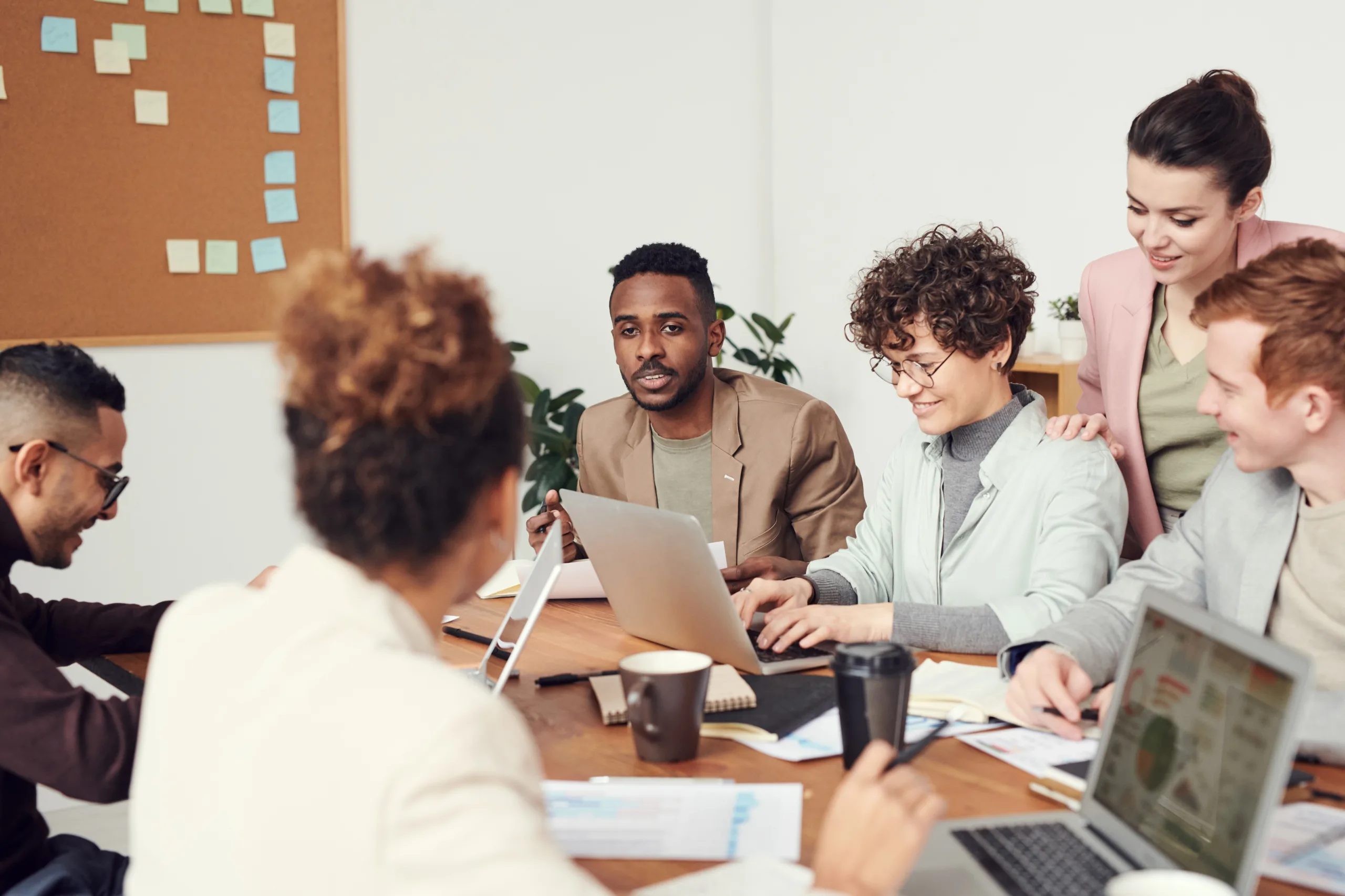 Group surrounding a laptop