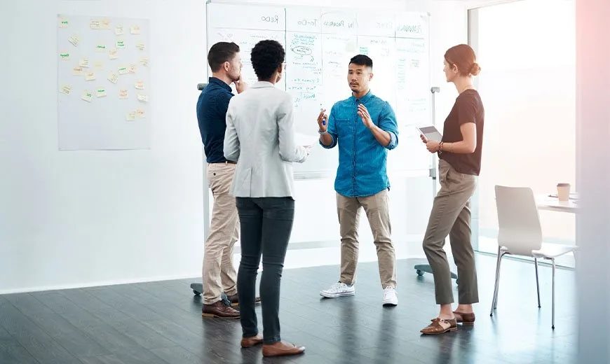 group of people standing up in a meeting